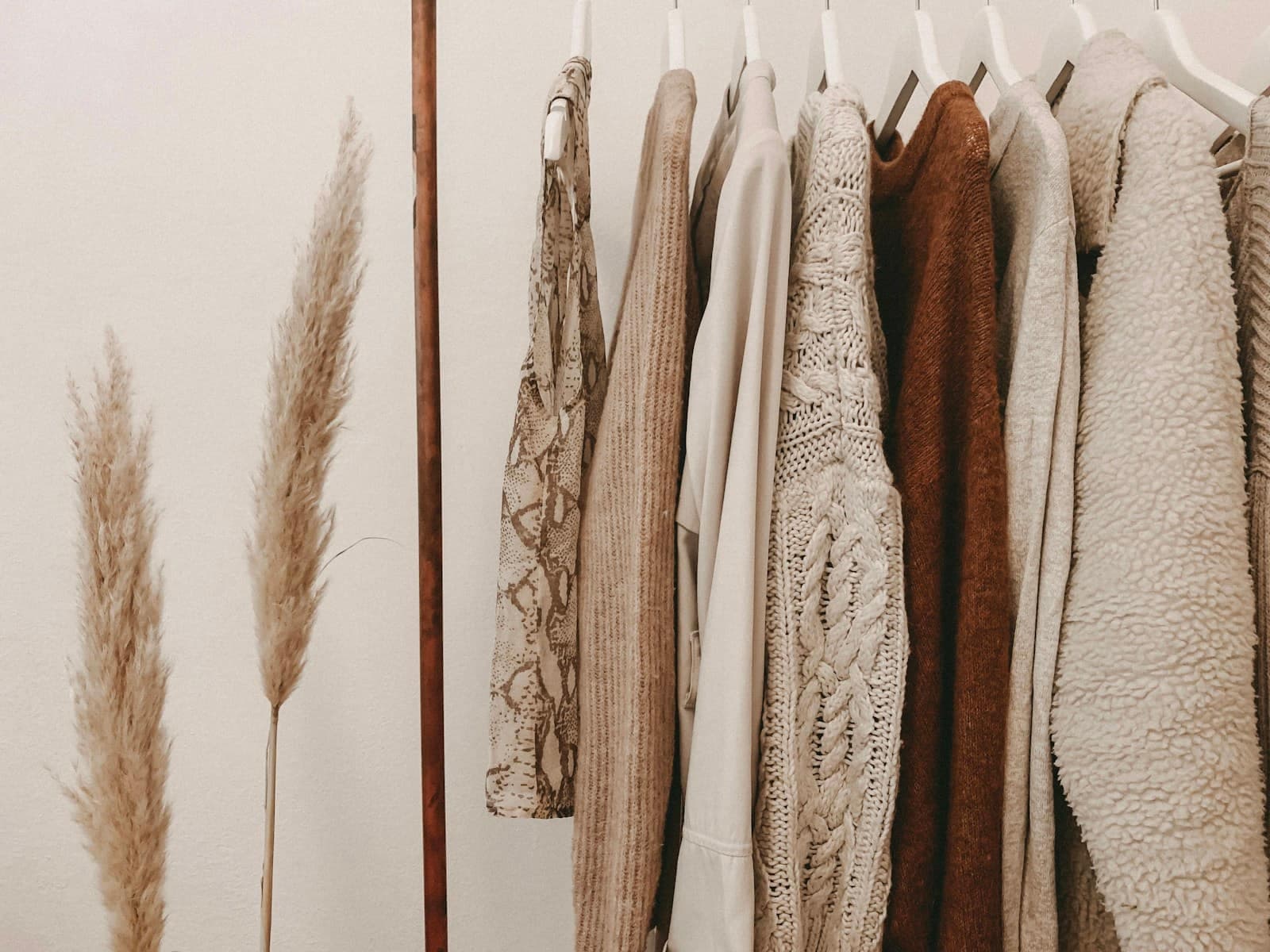 Neatly folded luxury cashmere and silk garments in neutral tones